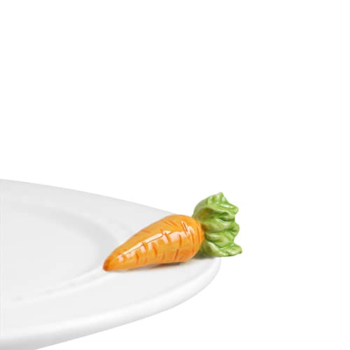 A plate with a glass carrot on it
